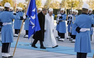 Pope Francis and Turkey's President Erdogan walk in front of honor guard at the presidential palace in Ankara